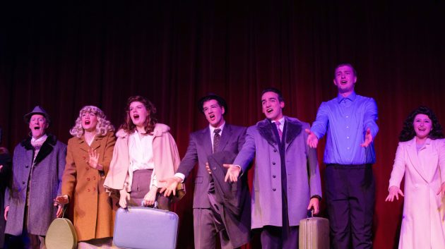 The main cast performing a number