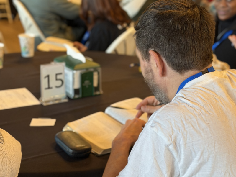 A man studying the bible during a message at thrive at the y