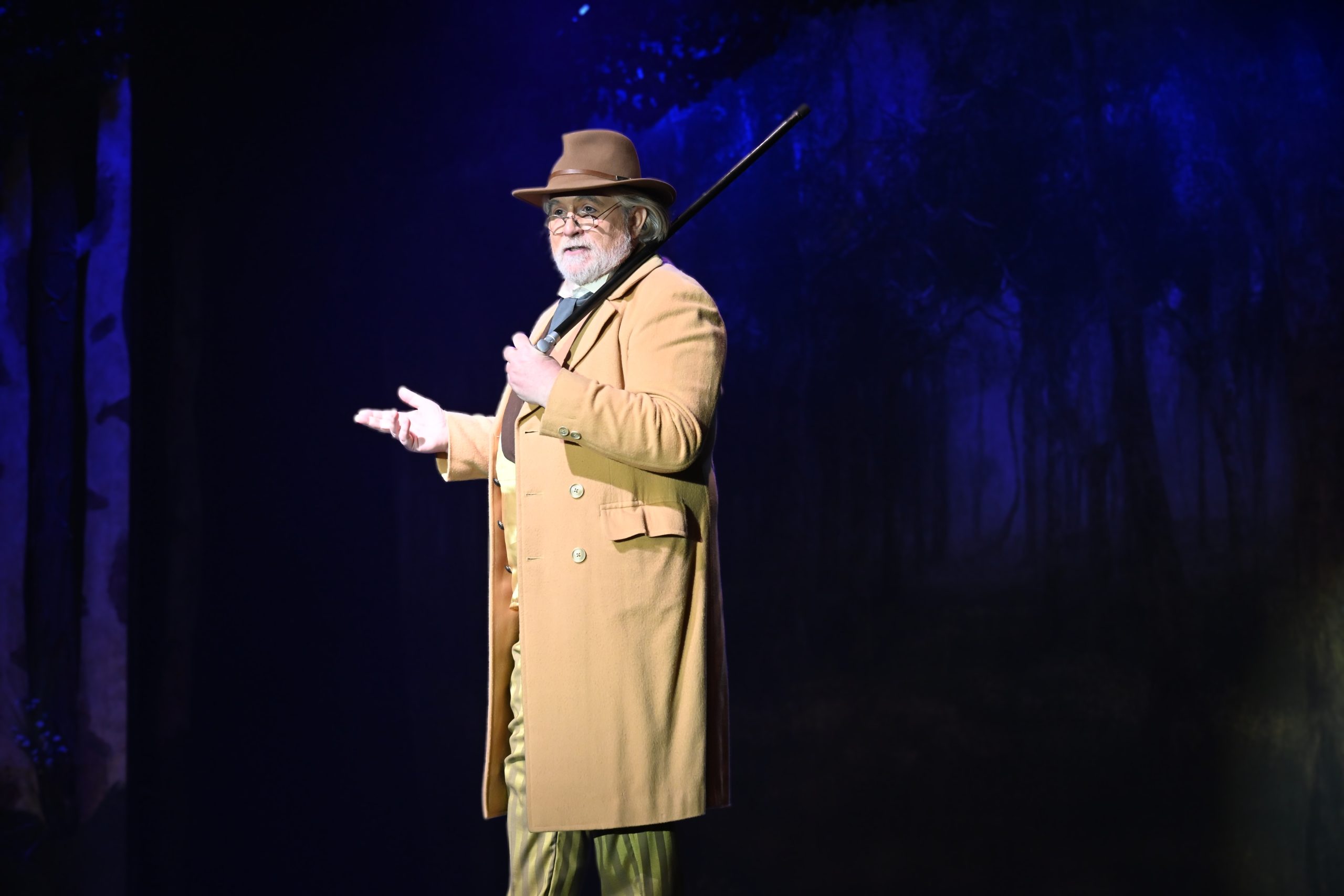 A man in a faded yellow suit